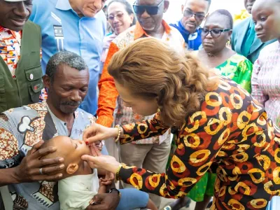La ministre de la Santé administre une dose de vaccin à un enfant.